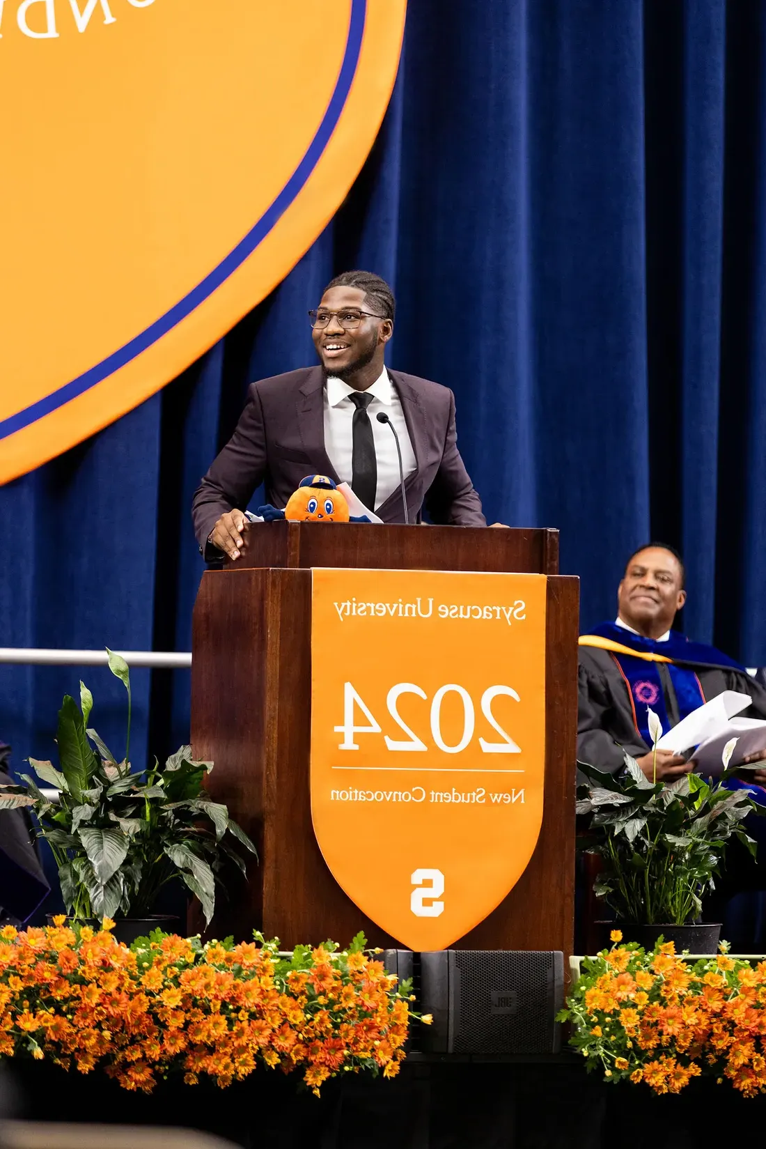 Alie Savane speaking at new student convocation.